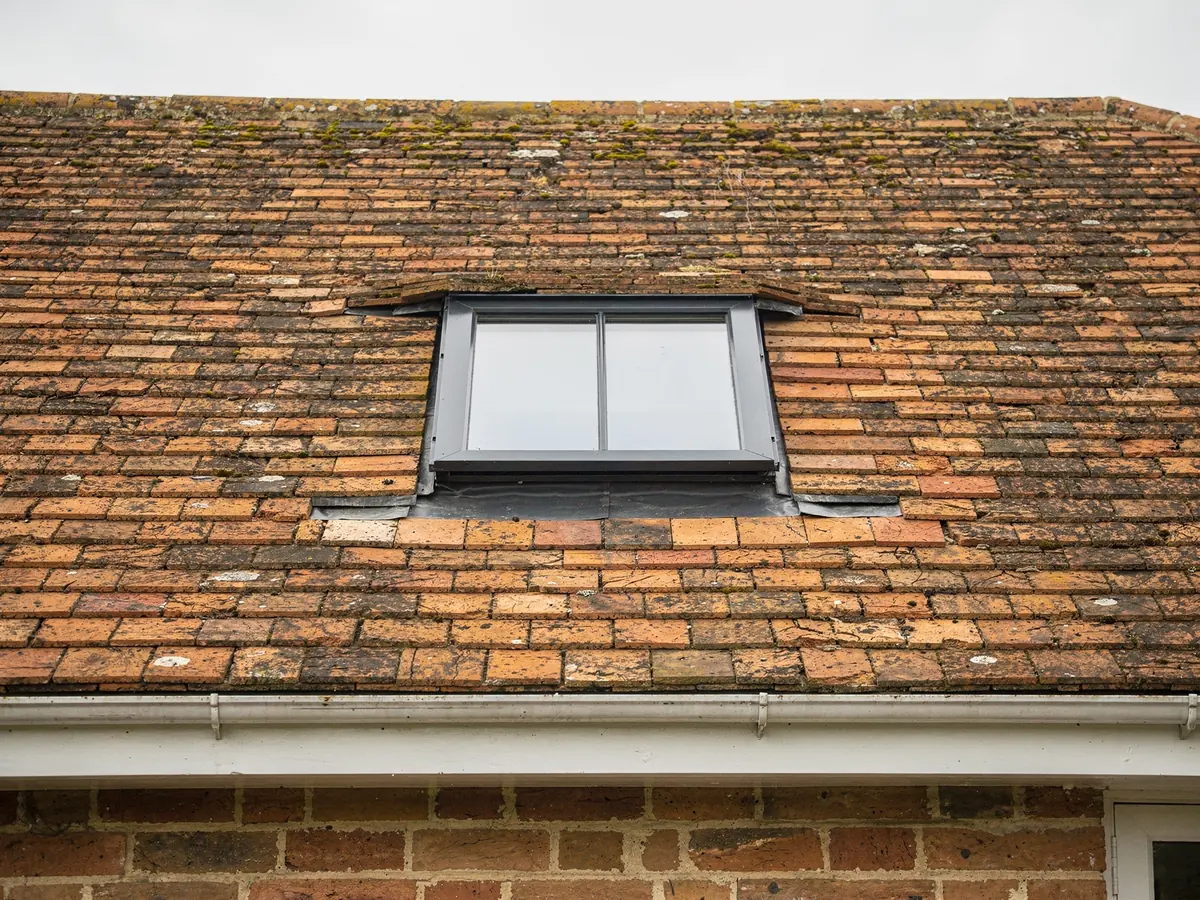 Conservation rooflight in a clay tile roof of a brick house
