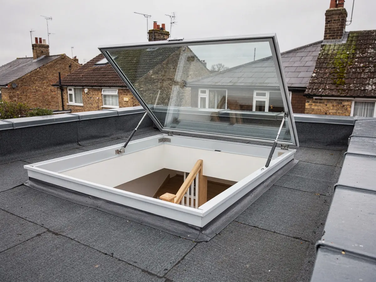 Access hatch rooflight opened onto a roof terrace