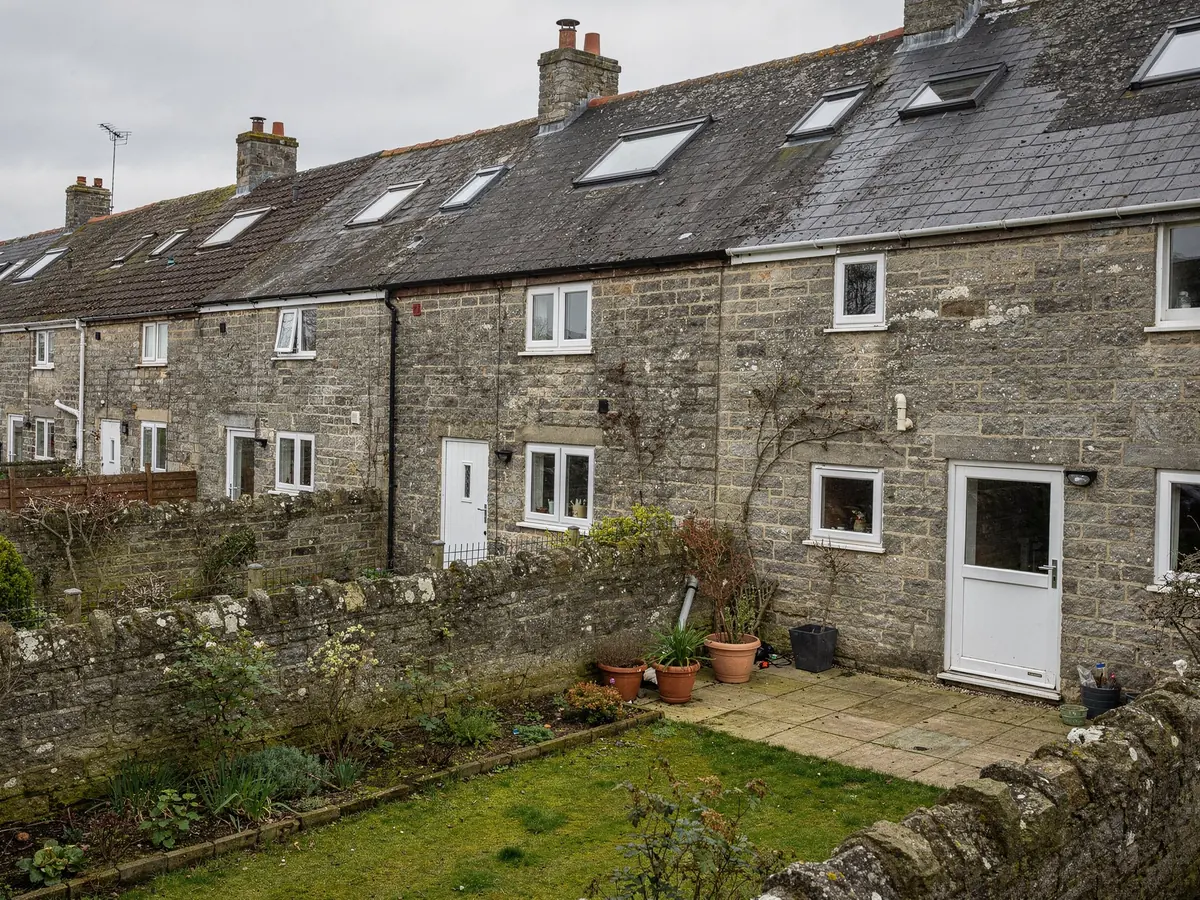 Rear of stone terraced cottages with roof windows