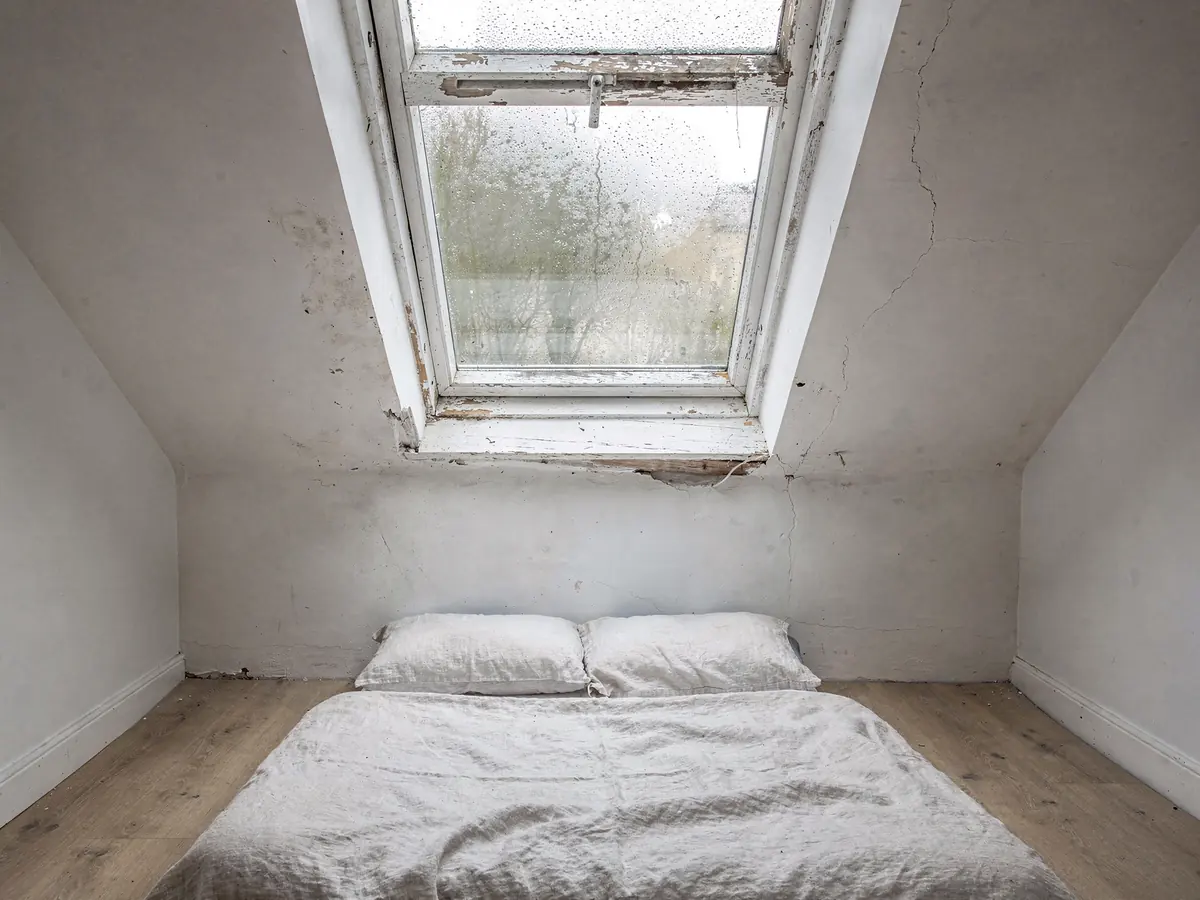 Older roof window with cloudy fogged glass